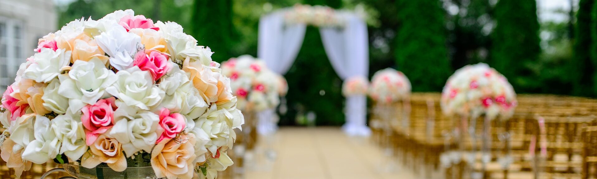 rows of chairs leading to a covered arch